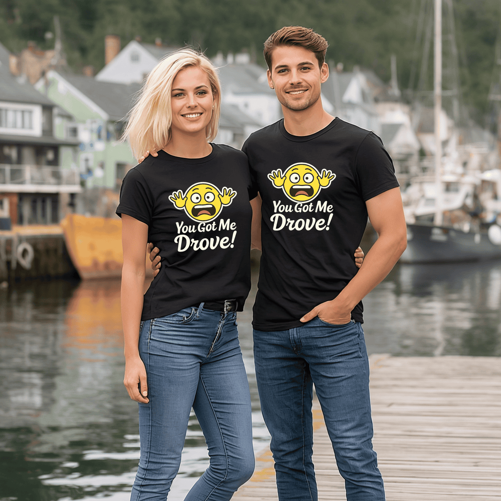 Two people wearing matching black t-shirts with a hysterical yellow emoji and text saying "You Got Me Drove," standing by a waterfront.
