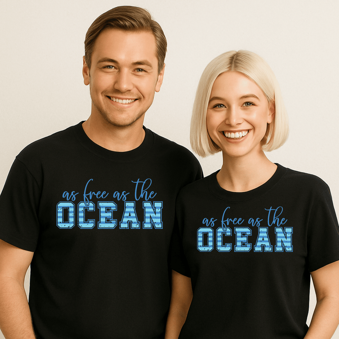 Black t-shirt with 'as free as the OCEAN' text, sunglasses, boots, and jeans on a white brick background