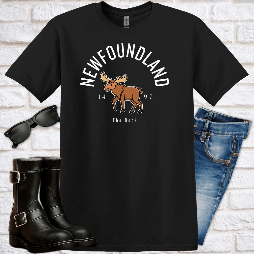 Black t-shirt with moose graphic and text saying Newfoundland, 1497, The Rock, sunglasses, boots, and jeans on a white brick background
