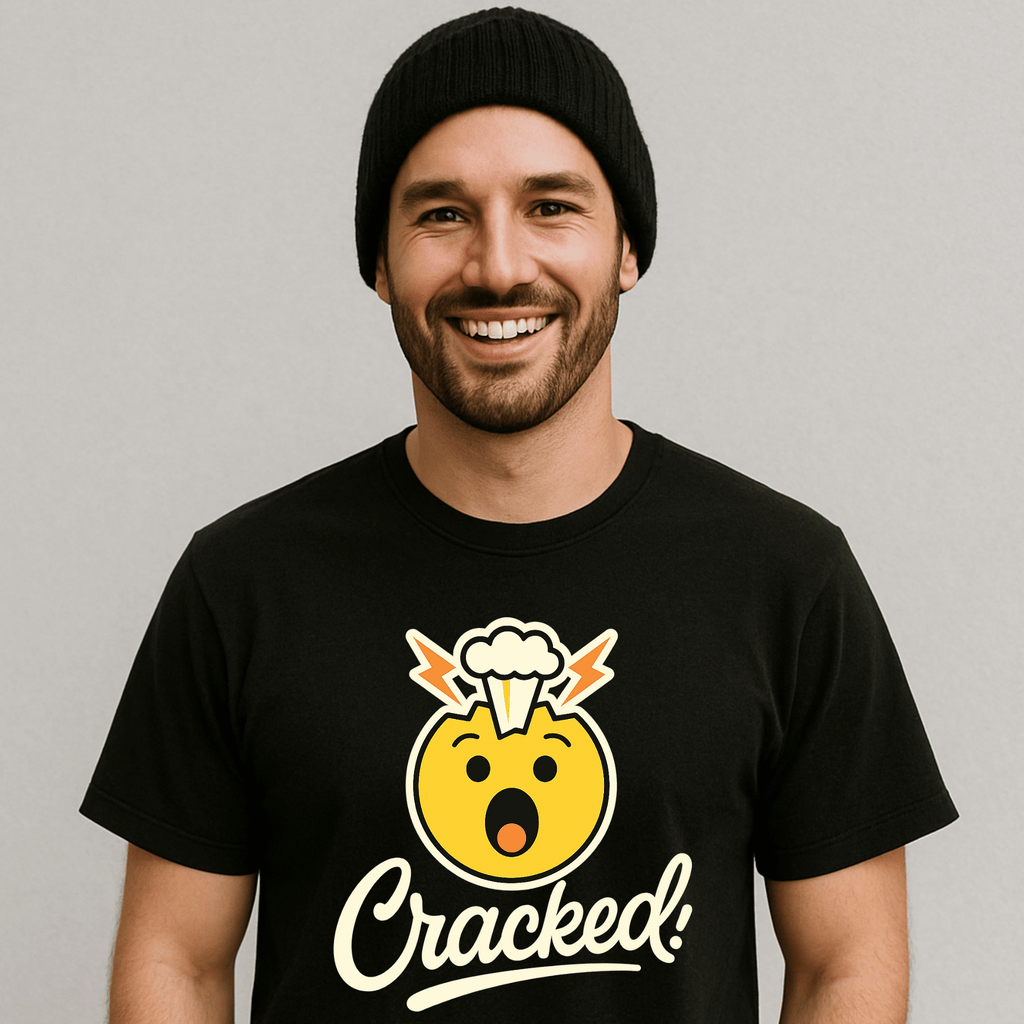 Man wearing a black t-shirt with a yellow emoji with a funny brain explosion and 'Cracked!' text on a white/gray background