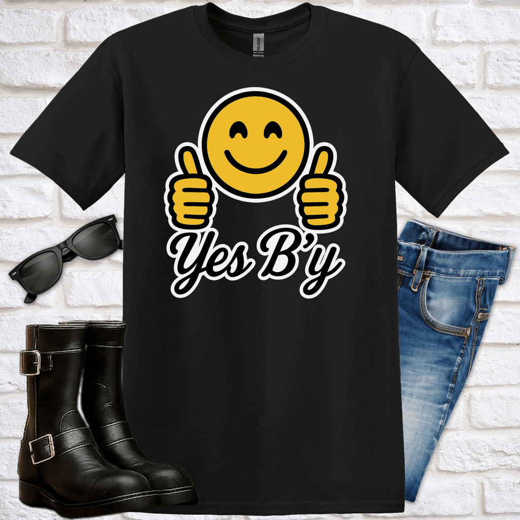 Black t-shirt with smiley face emoji and 'Yes B'y' text, sunglasses, boots, and jeans on a white brick background
