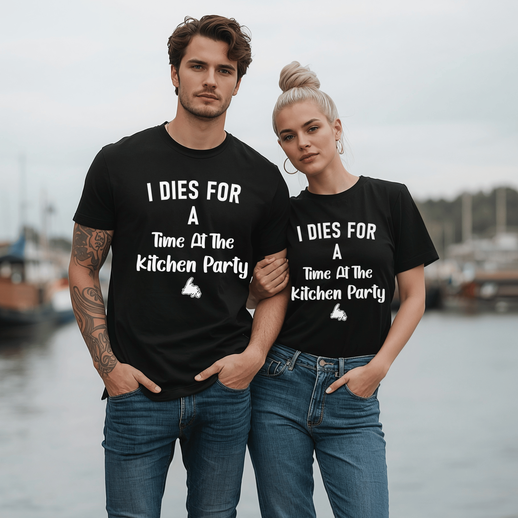 An attractive couple wearing matching t-shirts saying "I dies for a time at the kitchen party" and a Newfoundland graphic.