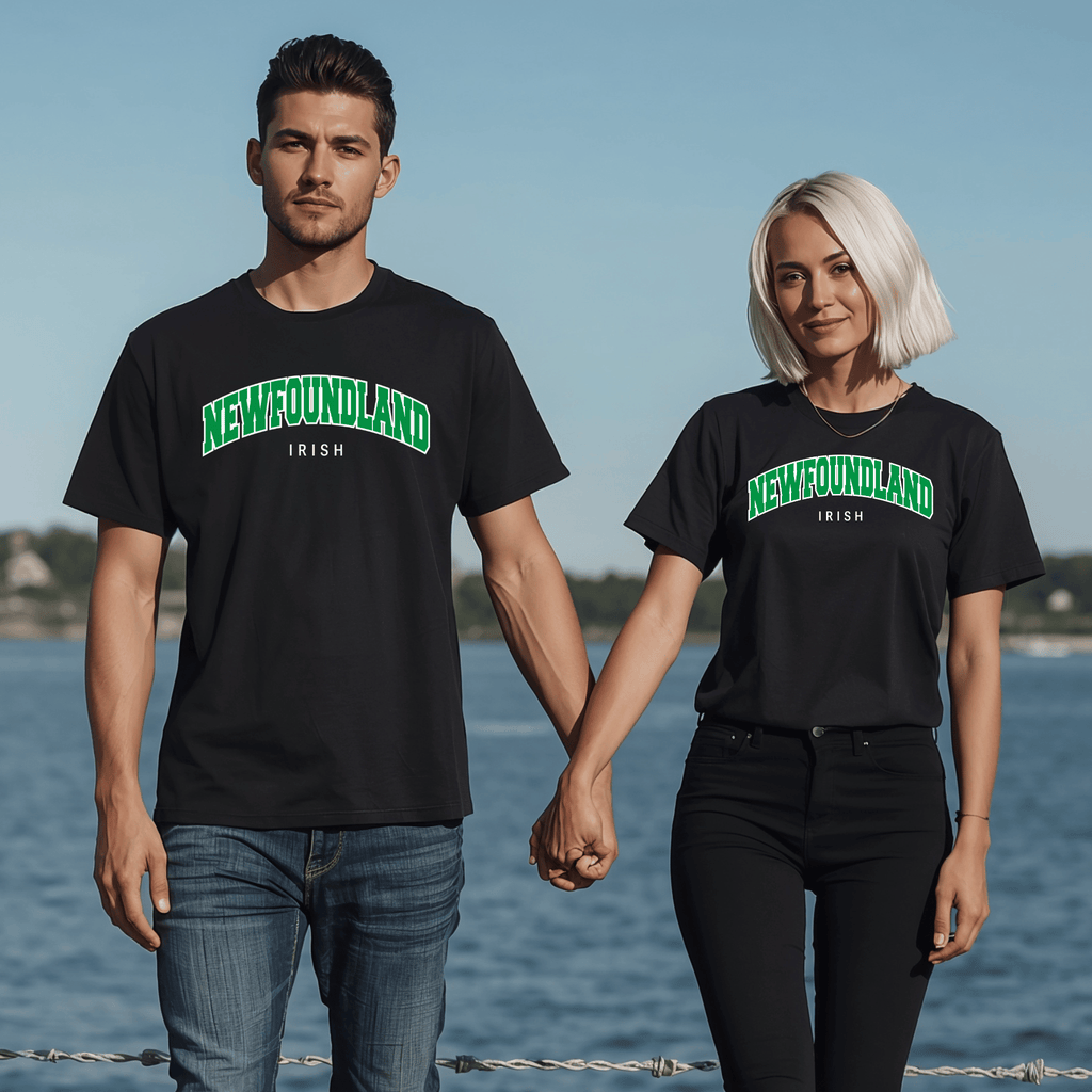 Two people holding hands by a body of water, wearing black t-shirts with 'Newfoundland Irish' text.