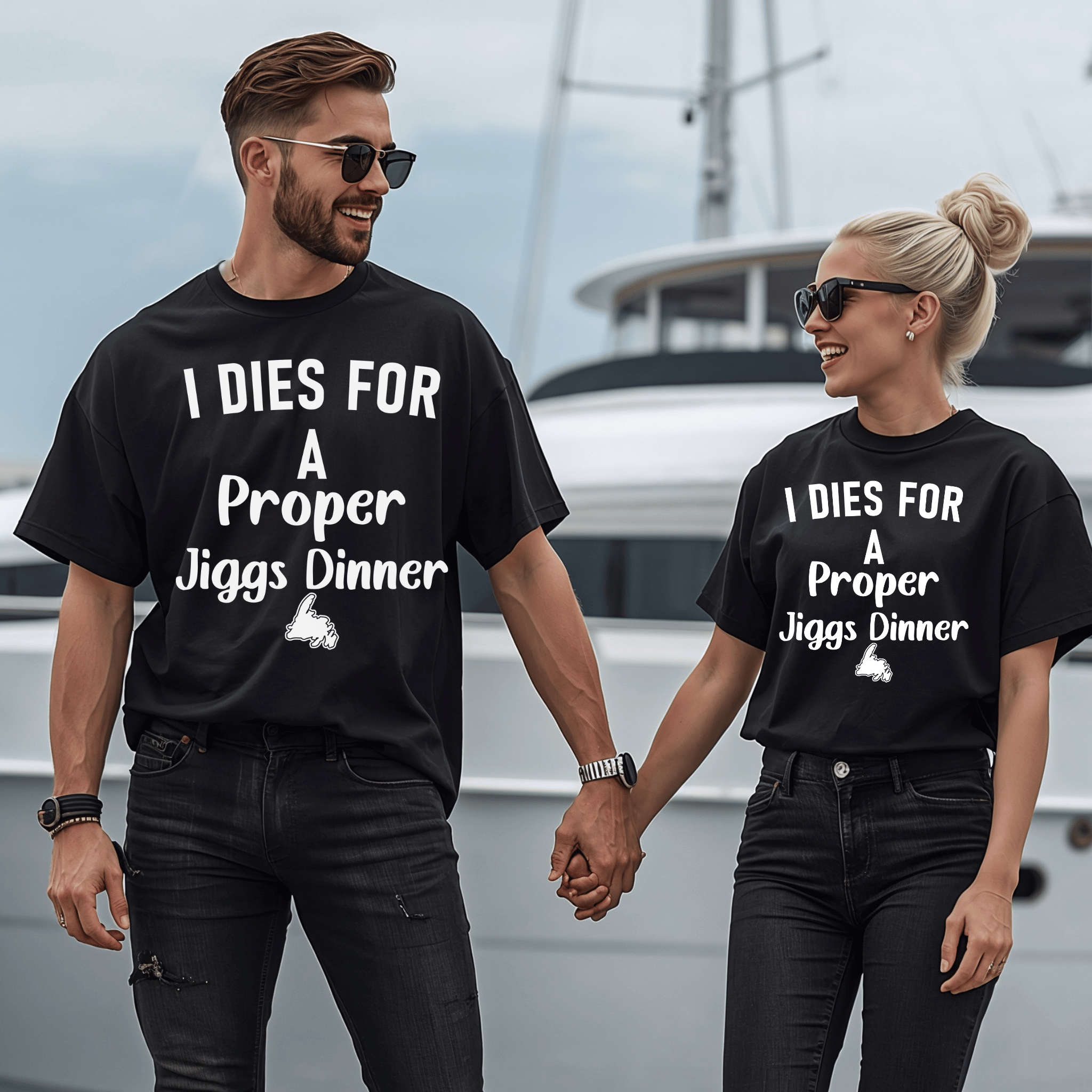 An attractive couple wearing matching black t-shirts with. a design of the text "I dies for a proper jiggs dinner" and a small Newfoundland graphic.