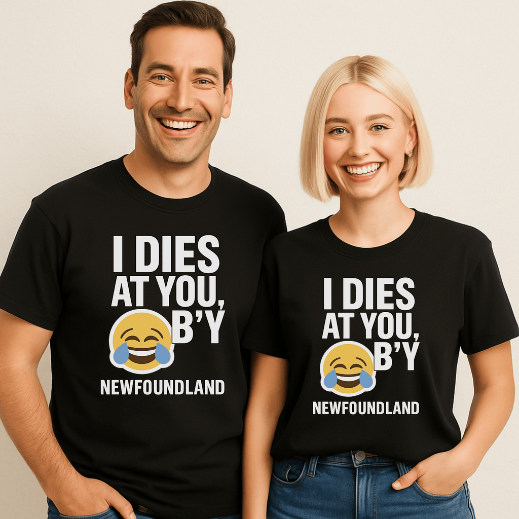 Two attractive people wearing black t-shirts with humorous text saying "I Dies at You B'y" and an emoji laughing until he is crying.