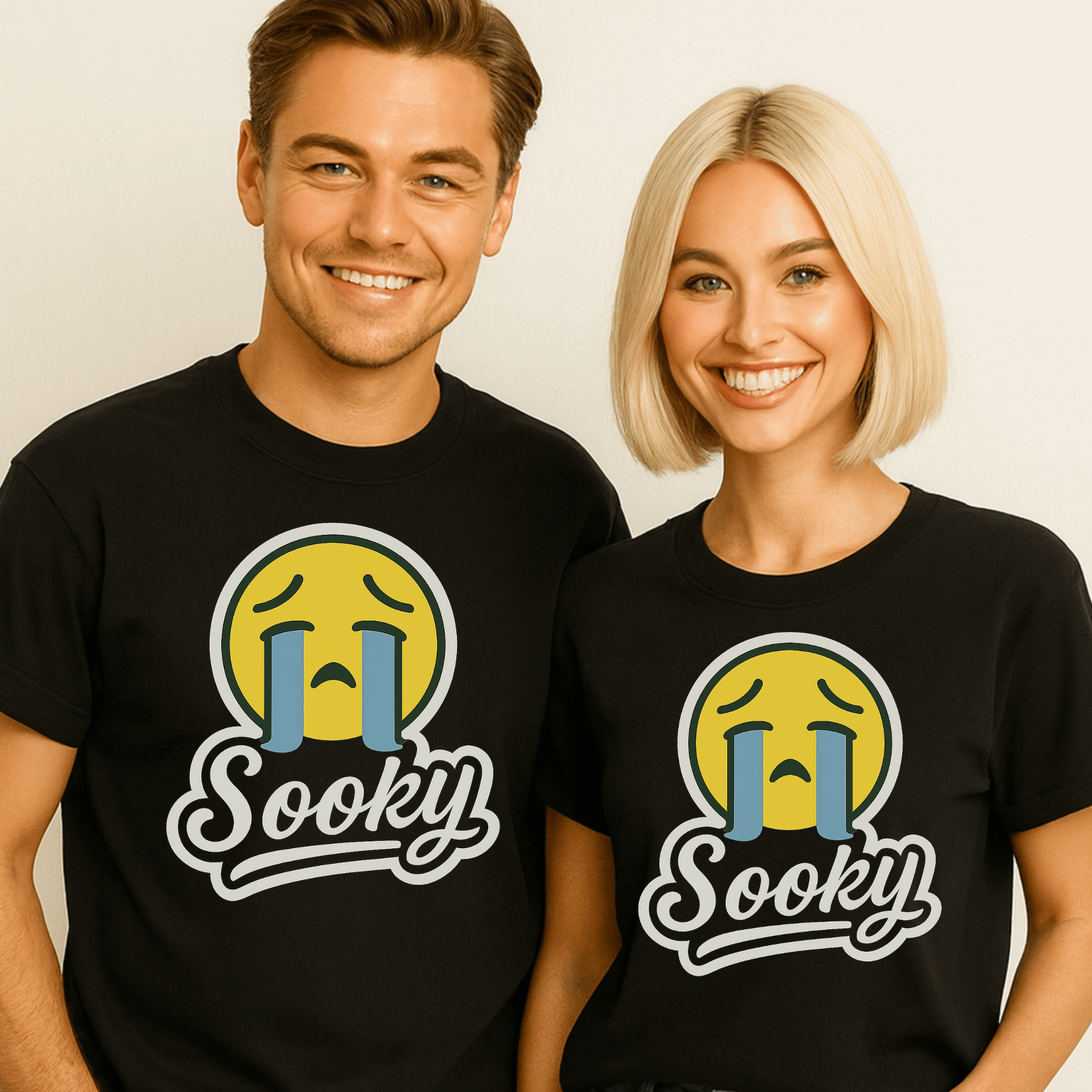 Two people wearing black t-shirts with a sad face emoji crying and 'Sooky' text on a plain background