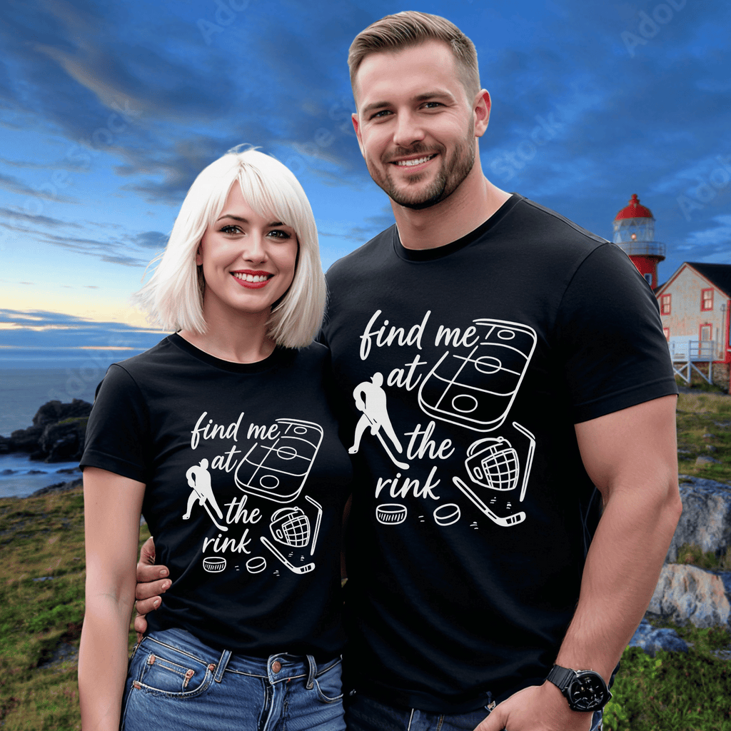 An attractive couple wearing matching black t-shirts with a hockey-themed design including the words "find me at the rink". A Newfoundland lighthouse is in the background.
