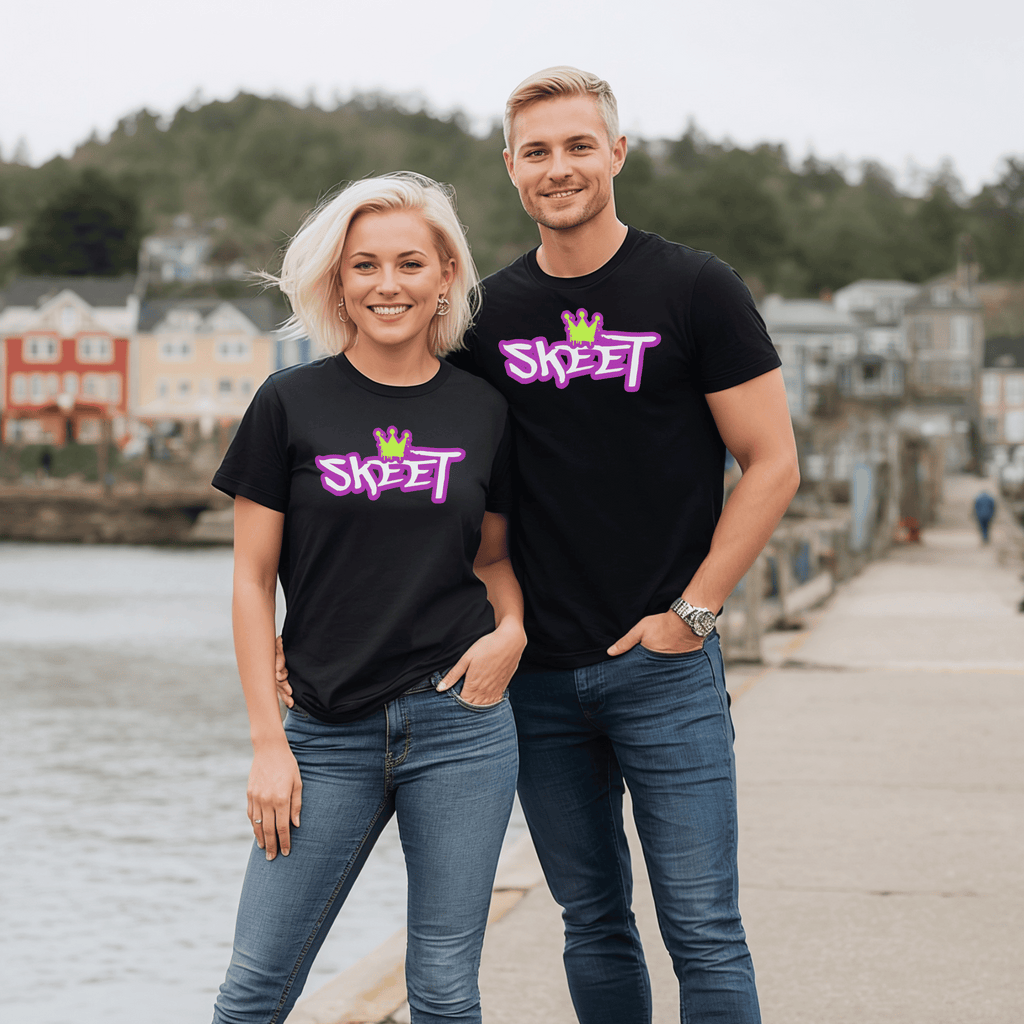 Two attractive people wearing black t-shirts with 'SKEET' logo standing by a waterfront.
