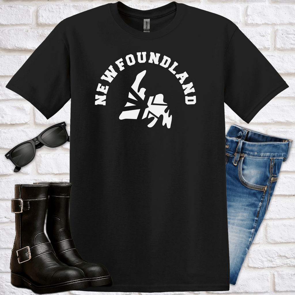 Black t-shirt with 'Newfoundland' design, of a map of Newfoundland with the word "Newfoundland" curved over it,  sunglasses, boots, and jeans on a white brick background