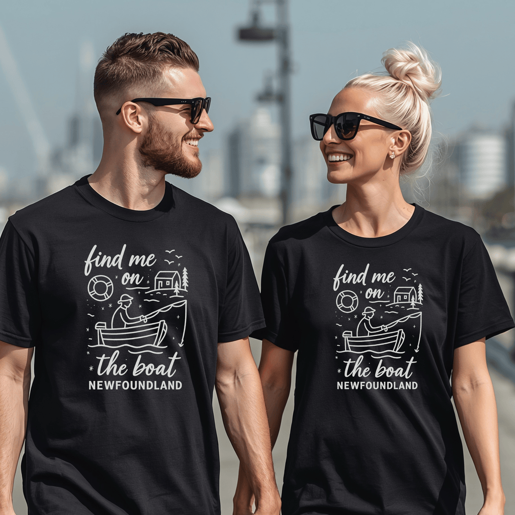 Two attractive people wearing matching black t-shirts with a boat graphic and text 'Find me on the boat, Newfoundland'.