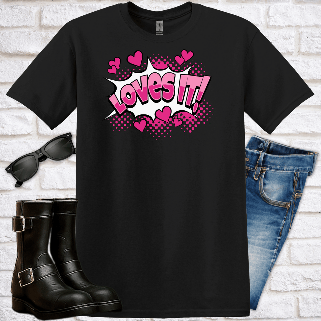 Black t-shirt with pink hearts graphics and the words "loves it!" with sunglasses, black boots, and blue jeans on a white brick background