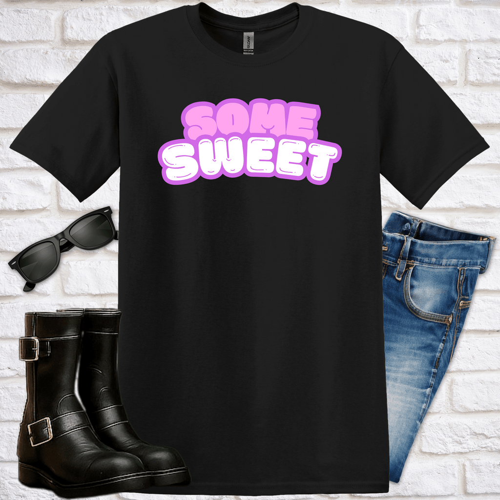 Black t-shirt with 'Some Sweet' text, sunglasses, boots, and jeans on a white brick background