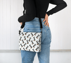 A model wearing the Puffin Parade Crossbody Purse by Newfinese Please