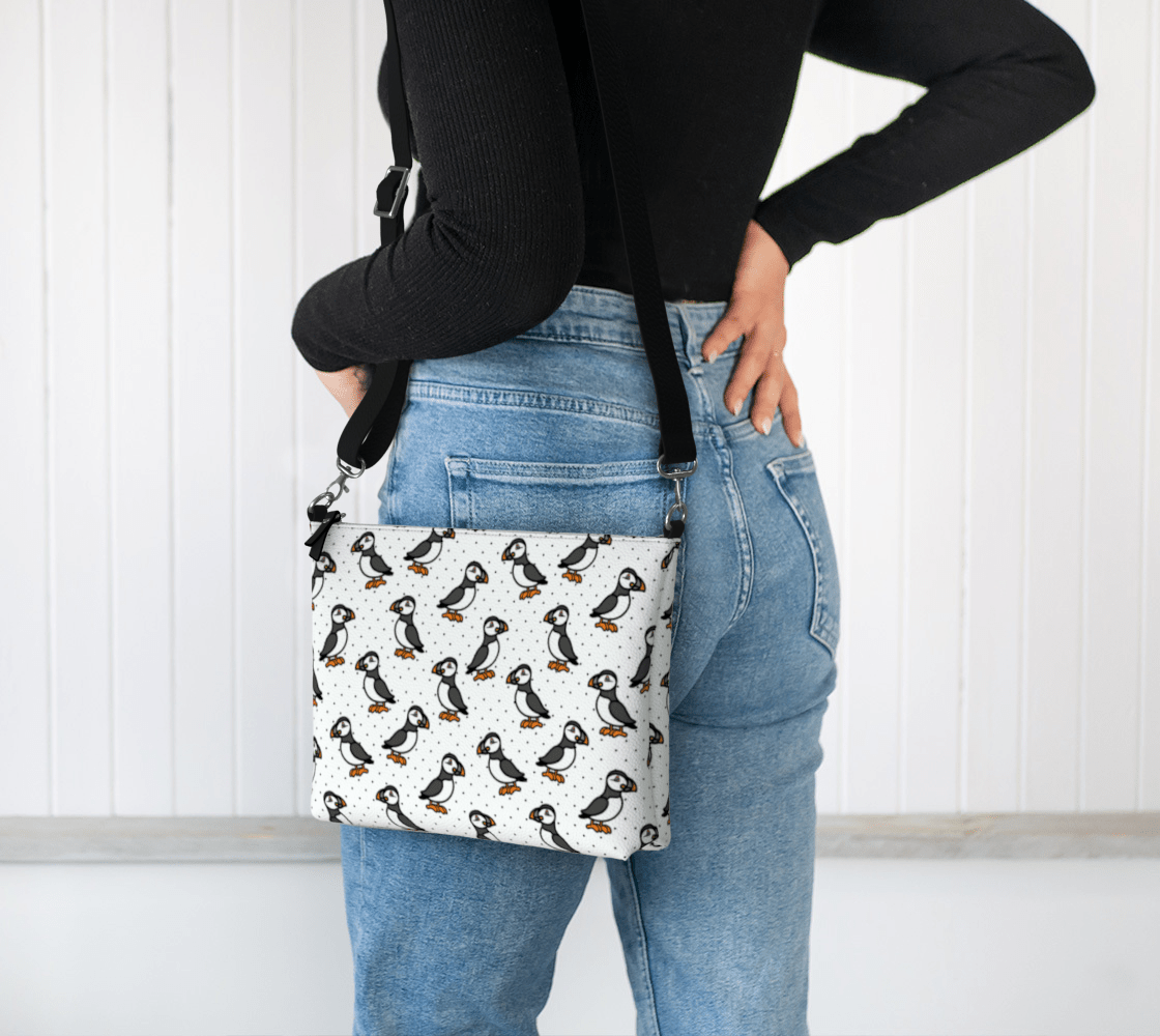 A model wearing the Puffin Parade Crossbody Purse by Newfinese Please