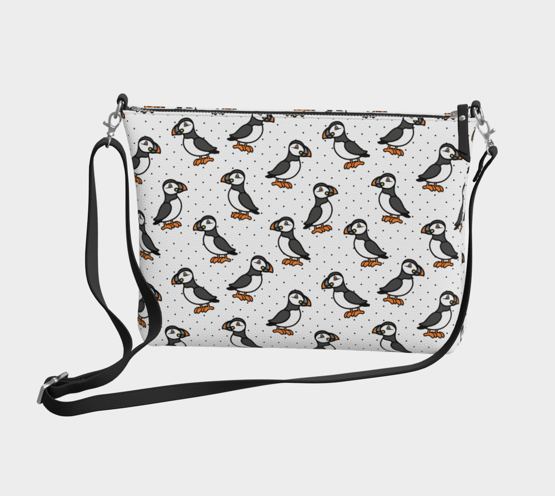 Take little puffins on the go with the vegan leather Puffin Parade Crossbody Purse. With its playful puffin print, this compact bag adds a fun, coastal touch.